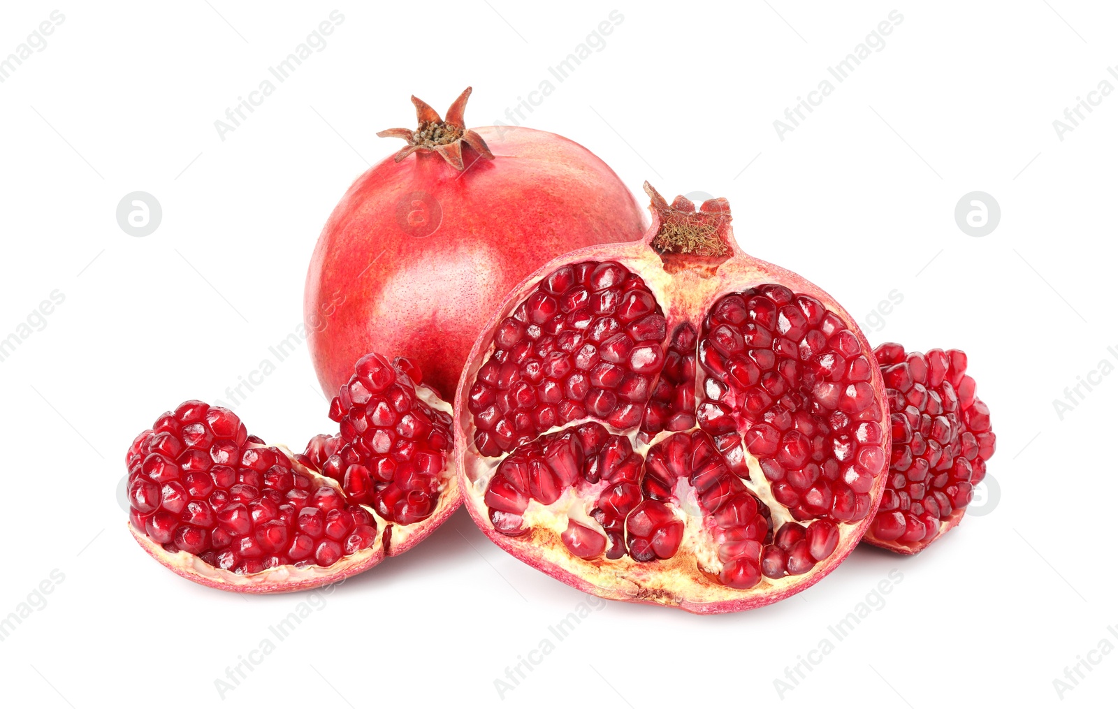 Photo of Cut and whole pomegranates isolated on white