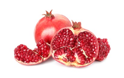 Photo of Cut and whole pomegranates isolated on white