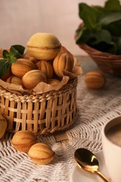 Photo of Walnut shaped cookies and mint on table. Homemade pastry filled with caramelized condensed milk