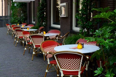 Photo of Beautiful view of outdoor cafe with stylish furniture