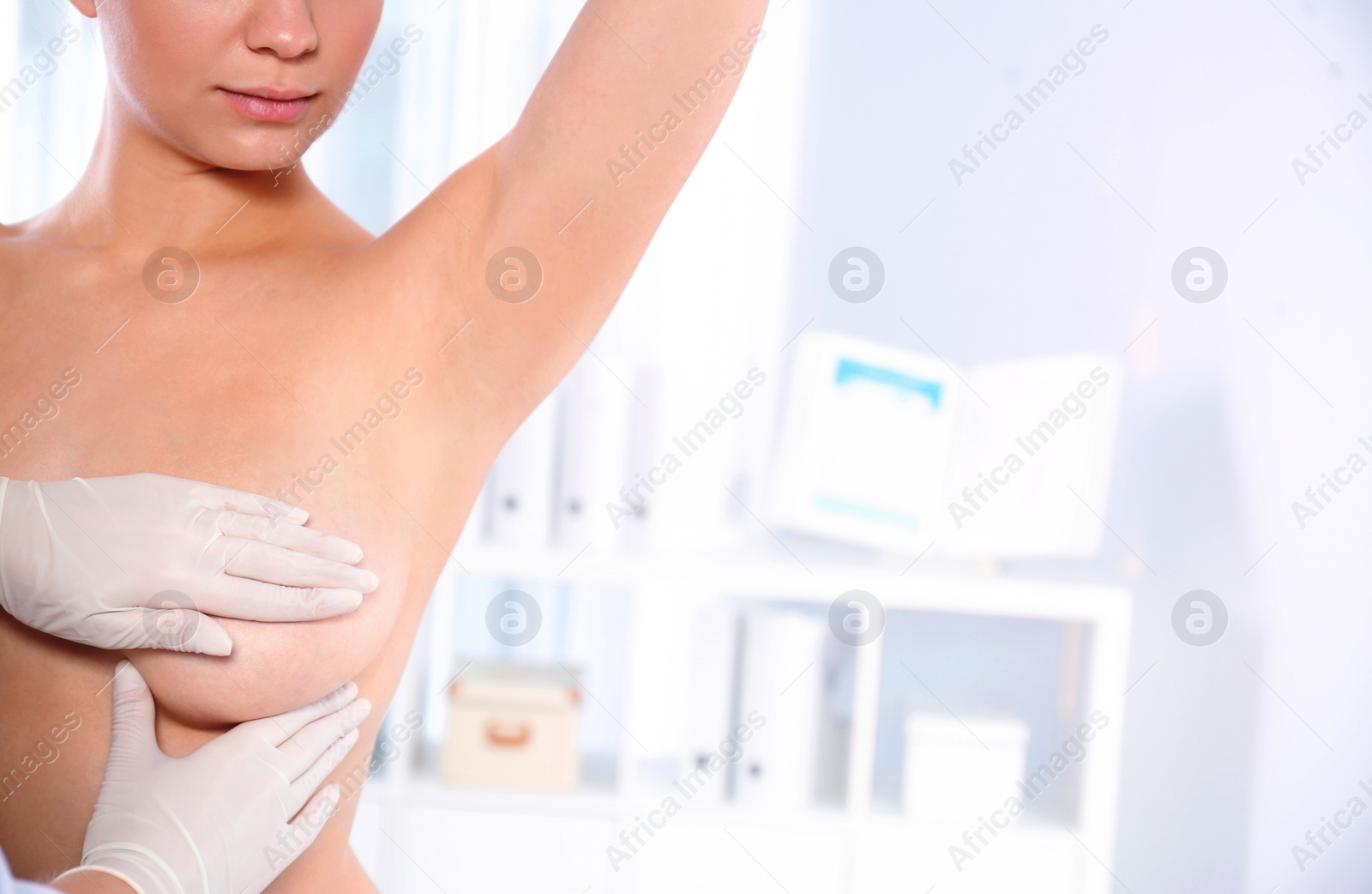 Photo of Doctor checking woman's breast at hospital, closeup. Space for text