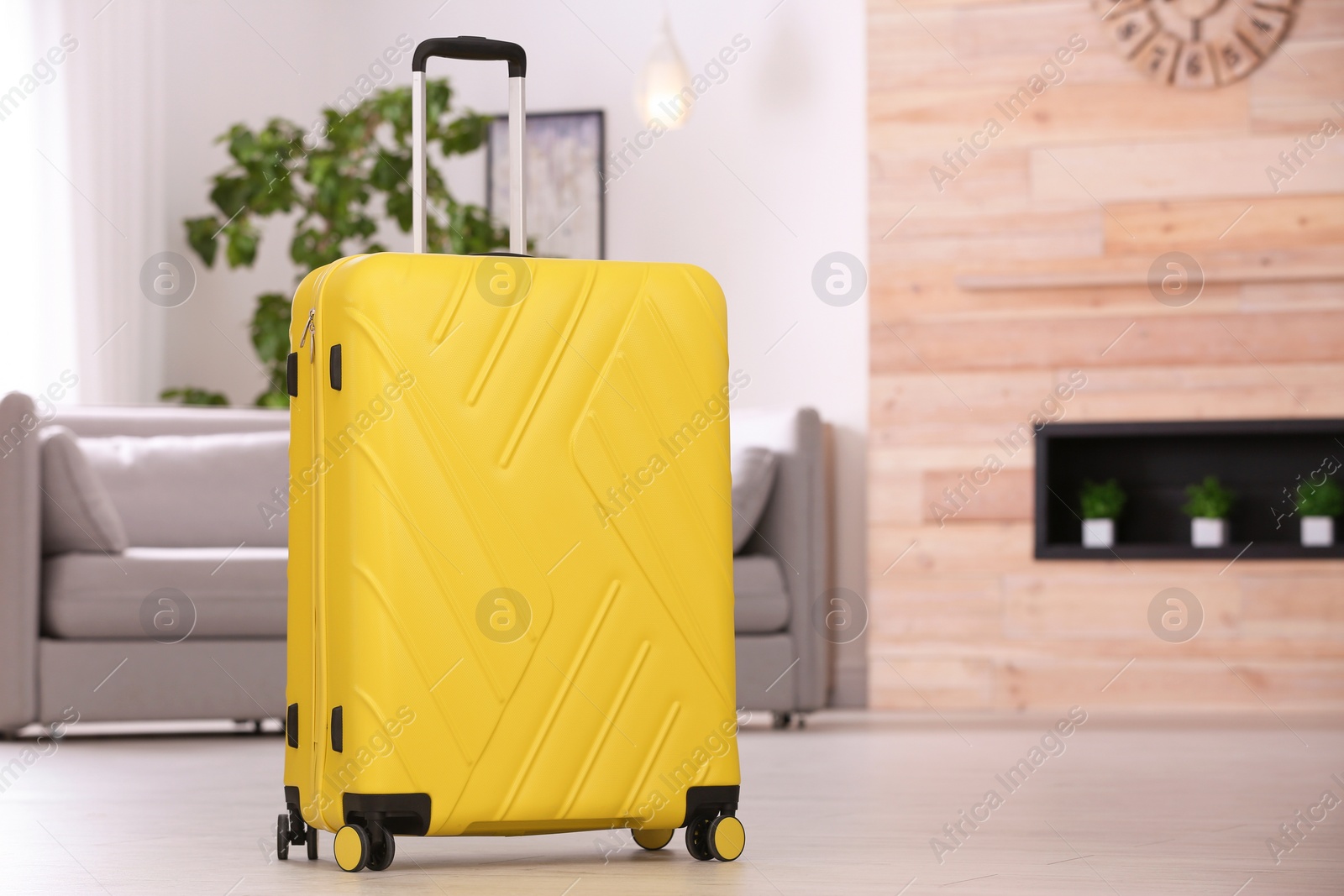 Photo of Colorful suitcase packed for journey in living room. Space for text