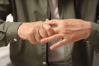 Photo of Senior man suffering from pain in hand, closeup. Rheumatism symptom