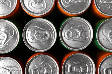 Energy drink in wet cans, top view. Functional beverage