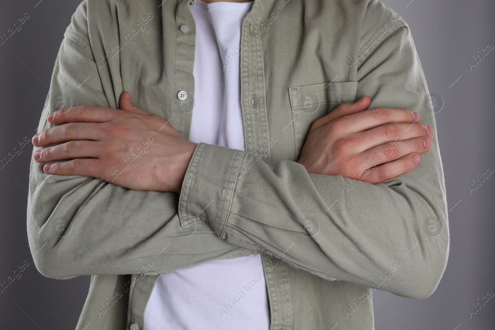 Photo of Man with space for tattoo on his hands against grey background, closeup