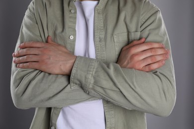 Photo of Man with space for tattoo on his hands against grey background, closeup