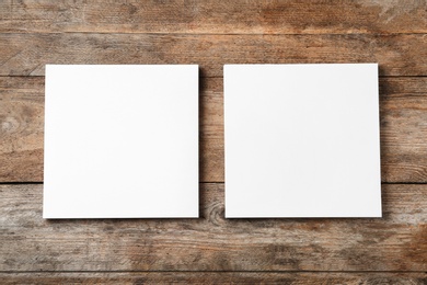 Blank paper sheets for brochure on wooden background, flat lay. Mock up