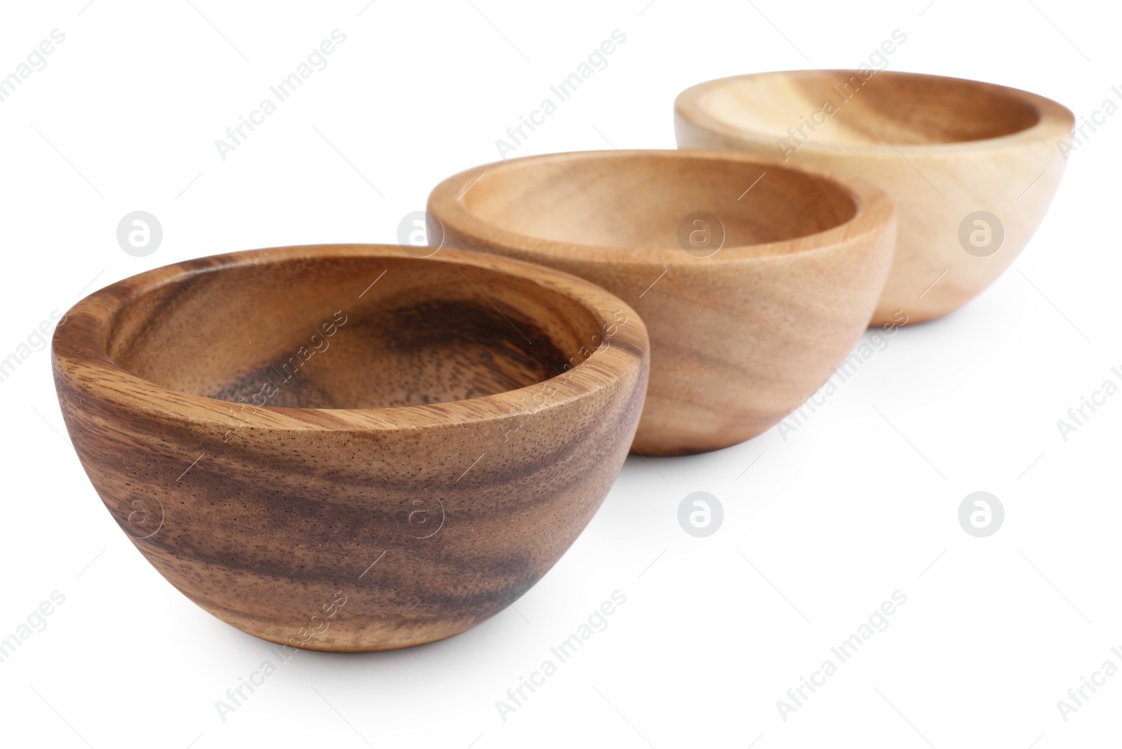 Photo of Set of wooden bowls on white background