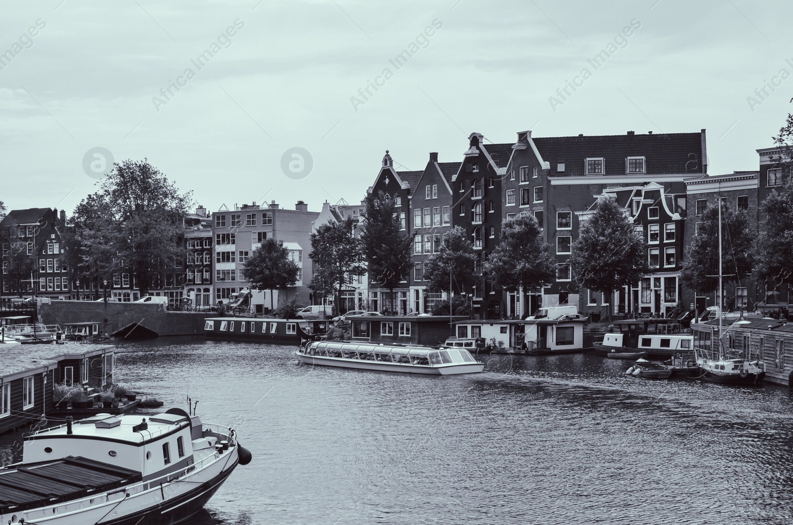 Image of Picturesque view of town with beautiful buildings near river. Black and white effect