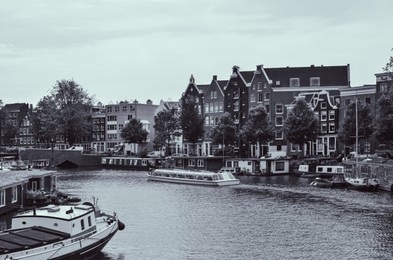 Picturesque view of town with beautiful buildings near river. Black and white effect