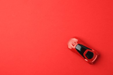 Photo of One bright car on red background, top view. Space for text