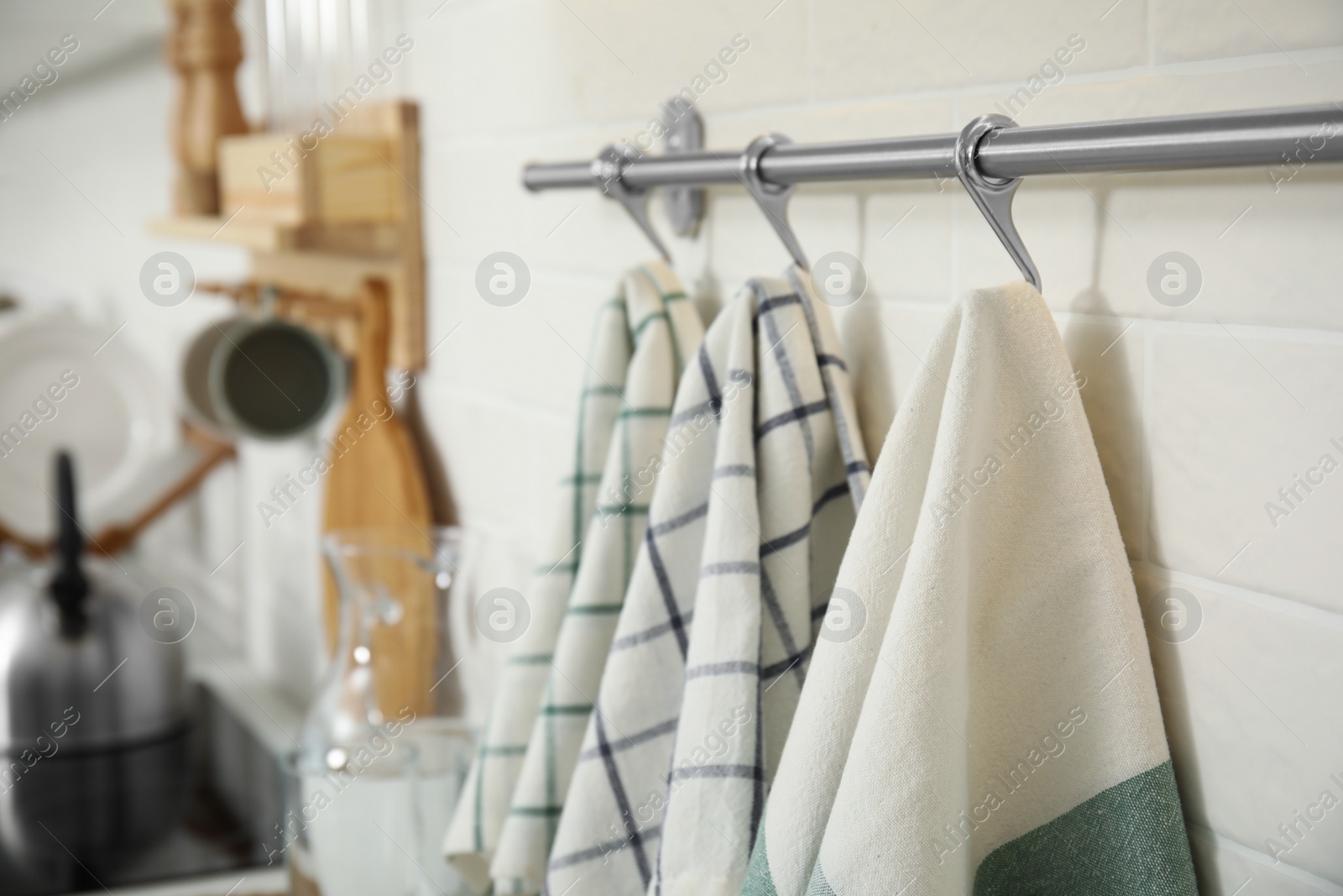Photo of Different clean towels hanging on rack in kitchen