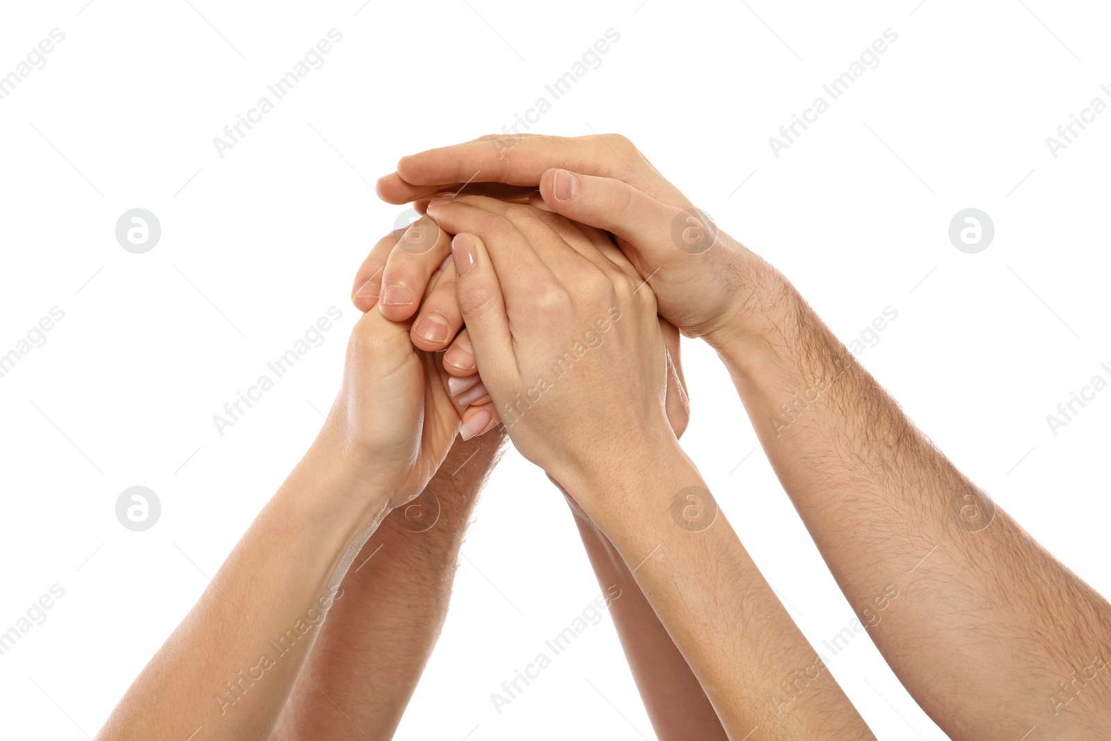 Photo of Young people holding hands together on white background, closeup. Team victory concept