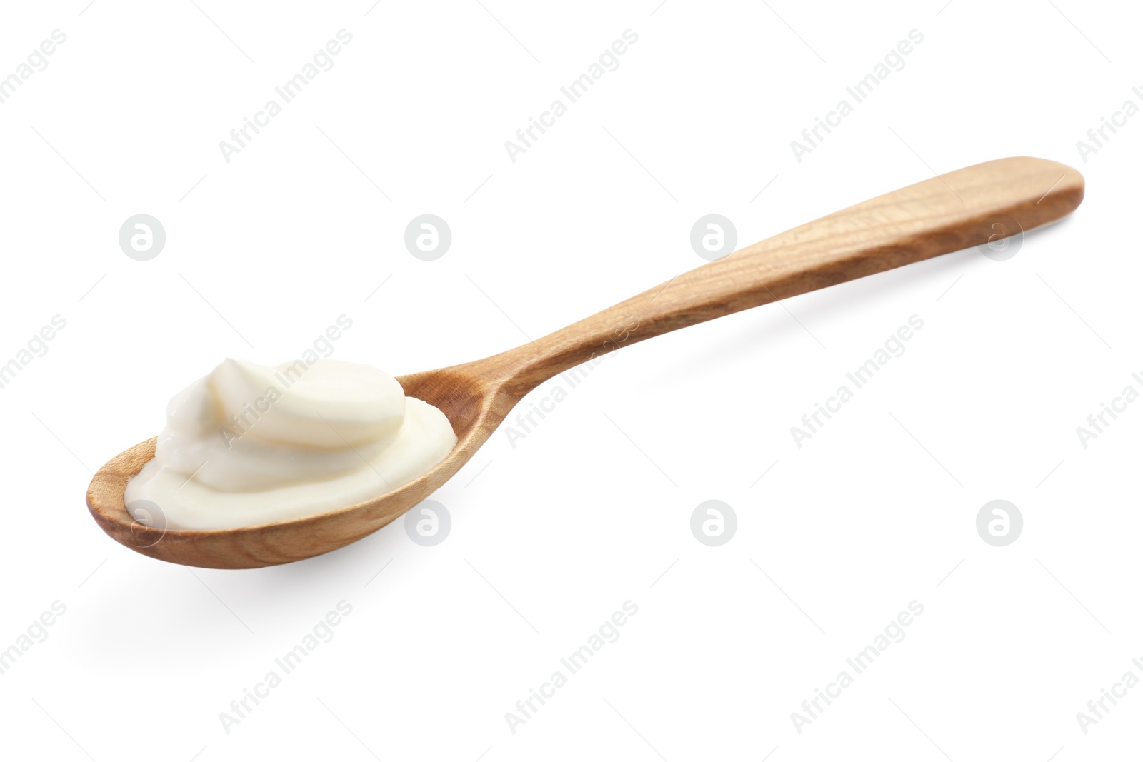 Photo of Sour cream in wooden spoon isolated on white