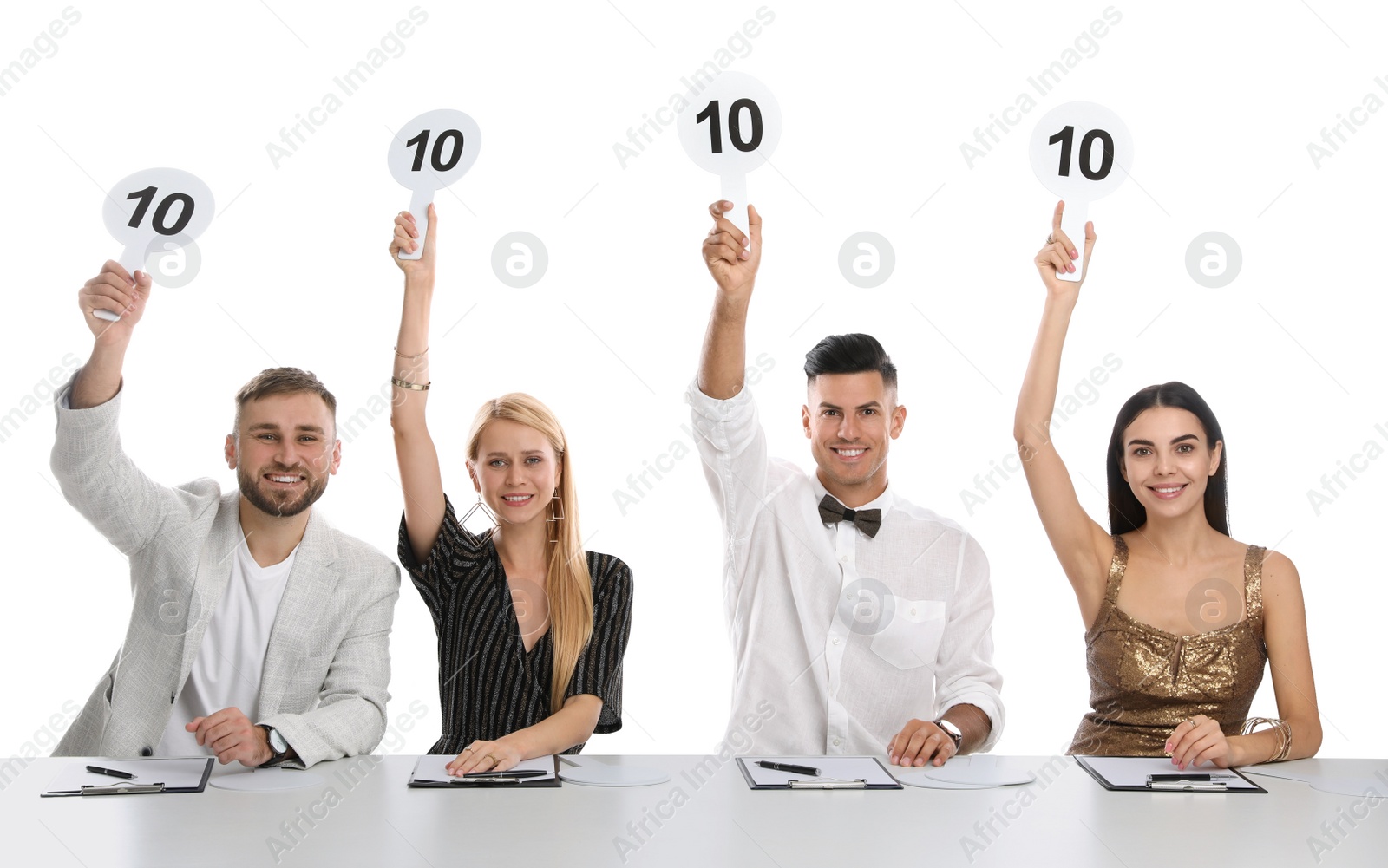 Photo of Panel of judges holding signs with highest score at table on white background