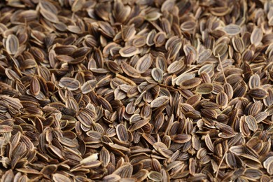 Photo of Many dry dill seeds as background, closeup