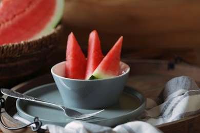 Fresh juicy watermelon in bowl on wooden tray, closeup