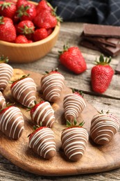 Delicious chocolate covered strawberries on wooden table