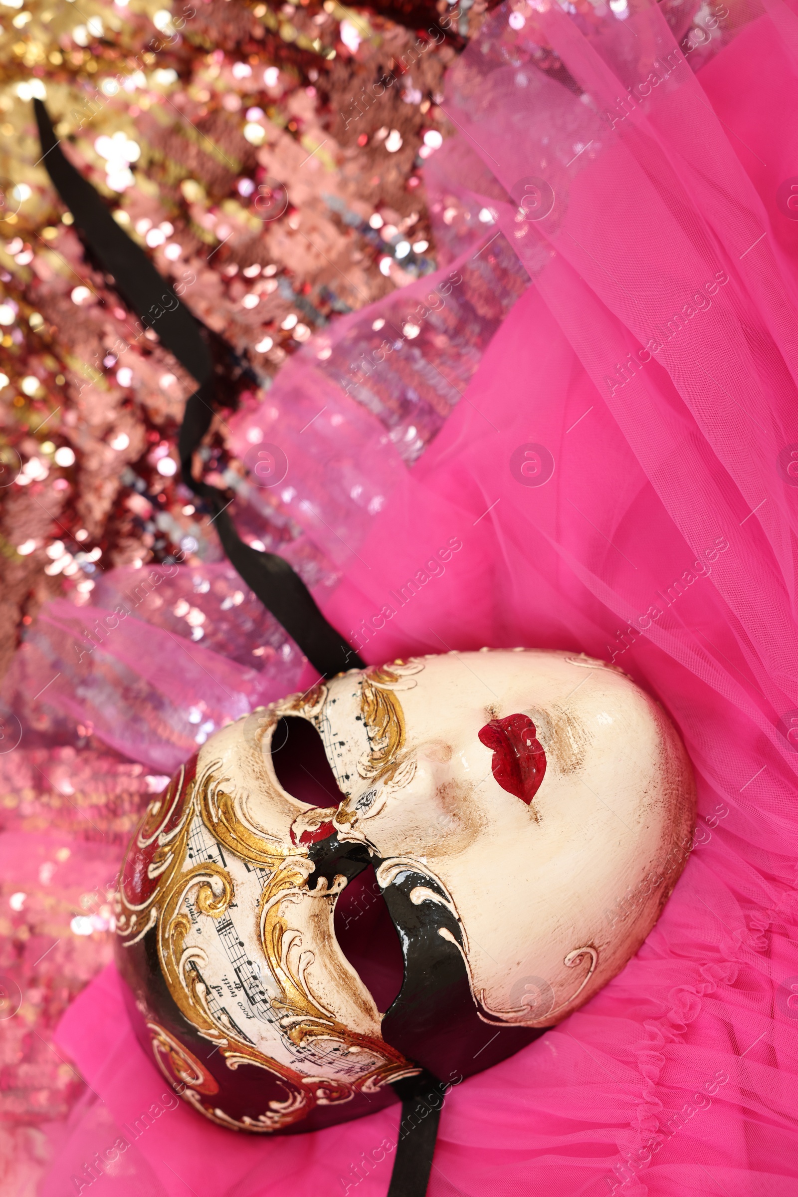 Photo of Carnival mask and beautiful pink costume with sequins, above view