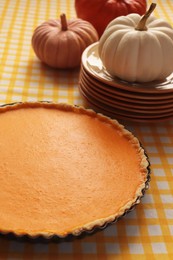 Delicious homemade pumpkin pie in baking dish on table