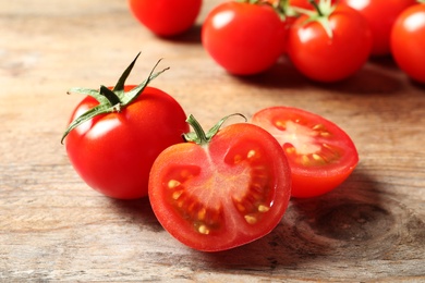 Photo of Fresh organic cherry tomatoes on wooden background