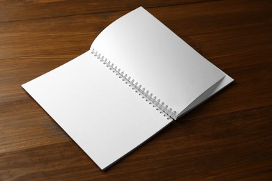 Blank paper brochure on wooden table. Mockup for design