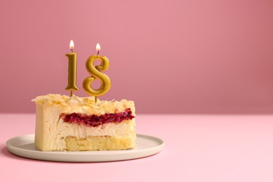 Photo of Coming of age party - 18th birthday. Delicious cake with number shaped candles on pink background, space for text