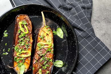 Photo of Frying pan with fried eggplant slices on table, top view