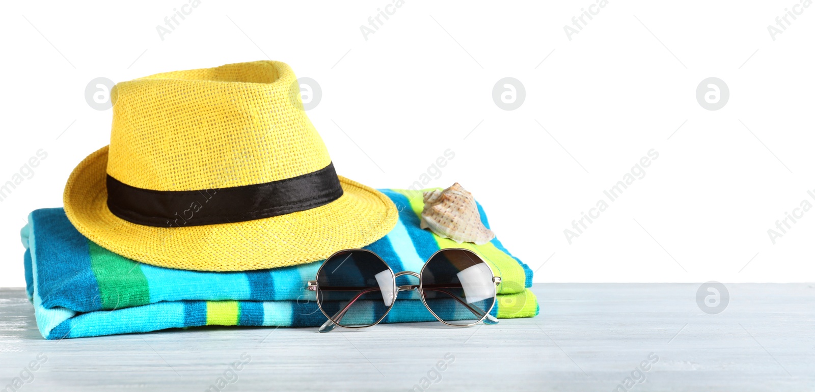 Photo of Composition with different beach objects on light blue wooden table, white background