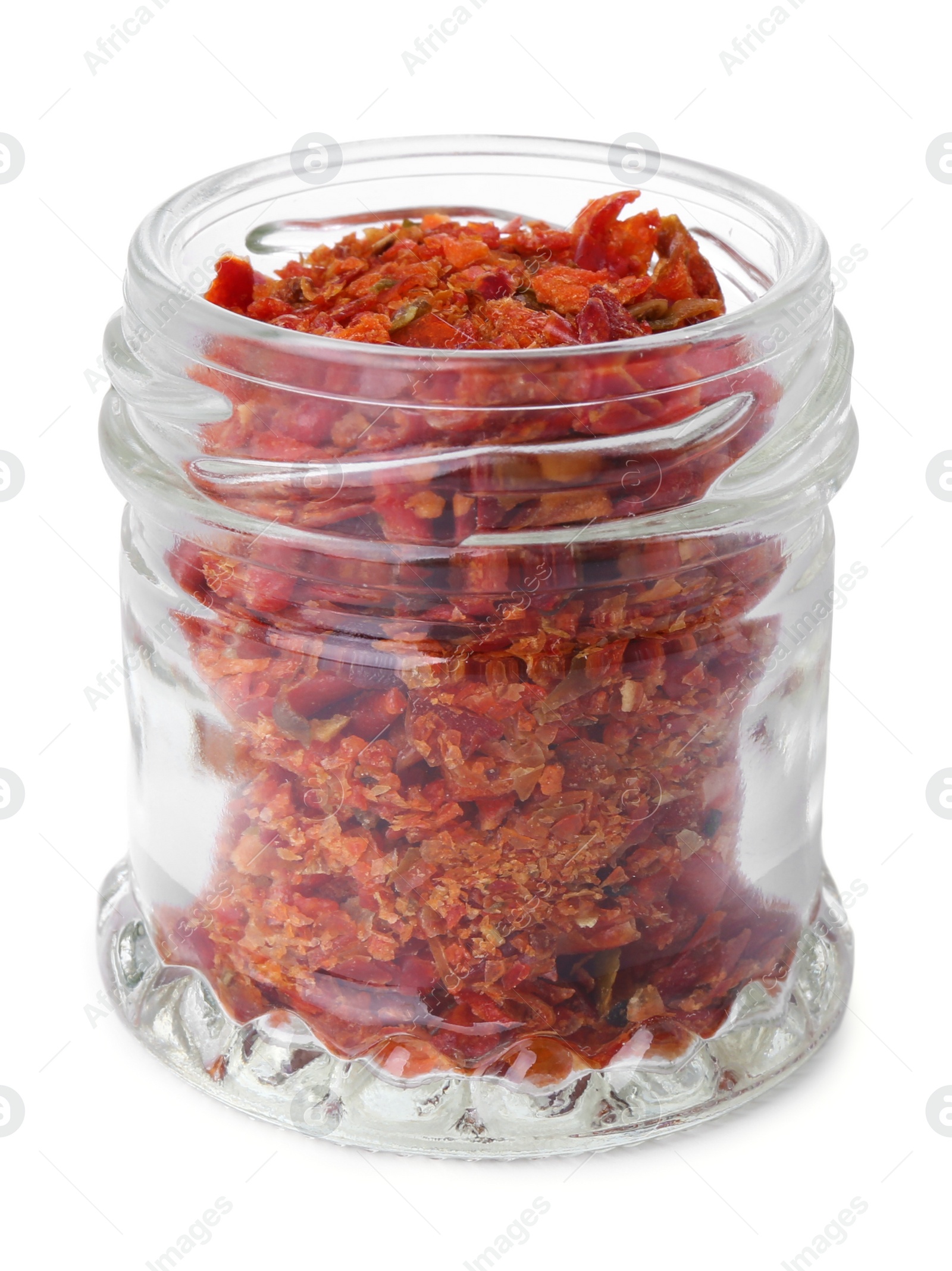 Photo of Aromatic spice. Red chili pepper flakes in jar isolated on white