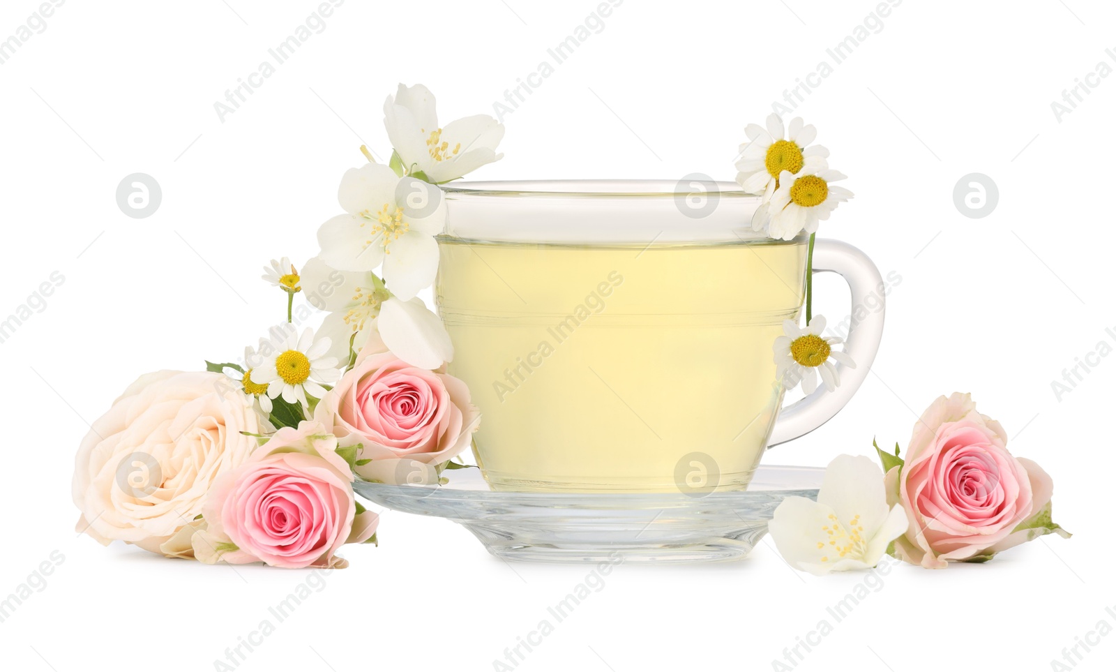 Photo of Aromatic herbal tea in glass cup and flowers isolated on white