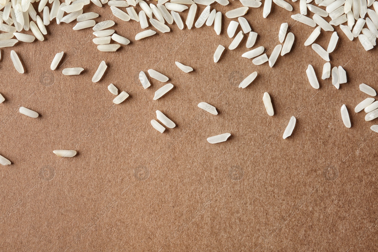 Photo of Long grain rice on color background, top view with space for text