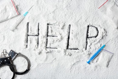 Photo of Composition with written word Help on cocaine powder, top view