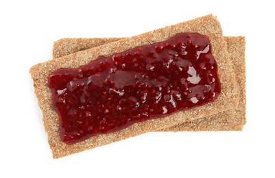 Photo of Fresh rye crispbreads with jam on white background, top view