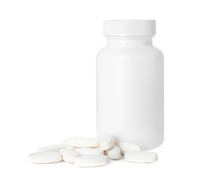 Bottle and pile of vitamin pills isolated on white