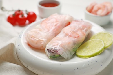 Photo of Delicious spring rolls with shrimps wrapped in rice paper on white wooden table, closeup
