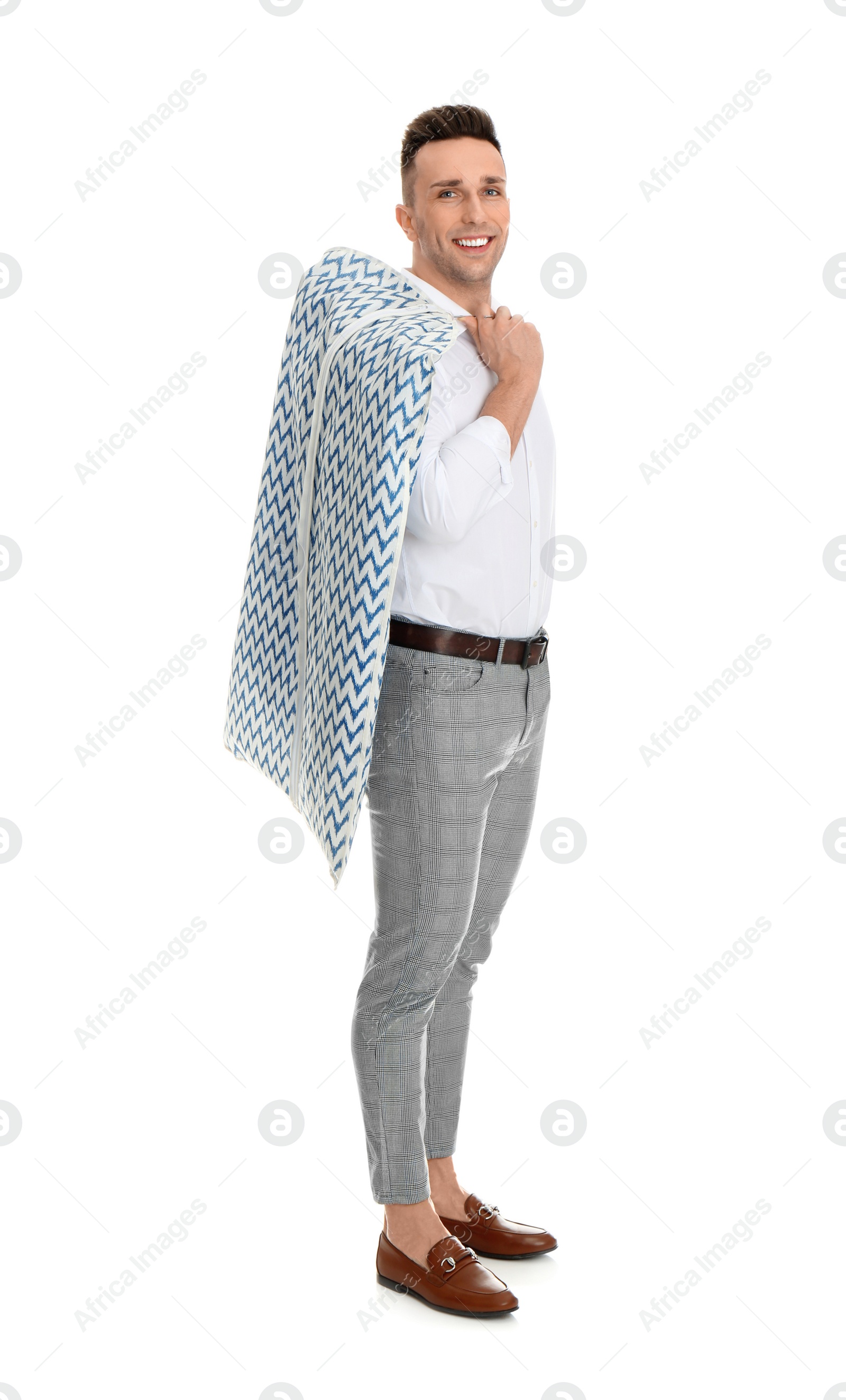 Photo of Man holding garment cover with clothes on white background. Dry-cleaning service