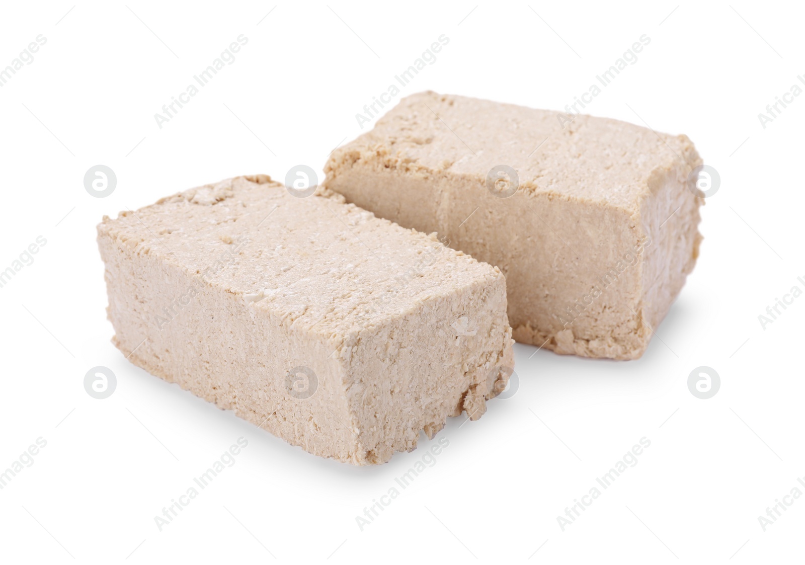 Photo of Pieces of tasty halva isolated on white