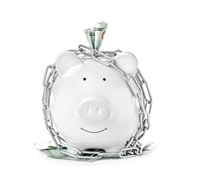 Photo of Piggy bank with steel chain isolated on white. Money safety concept