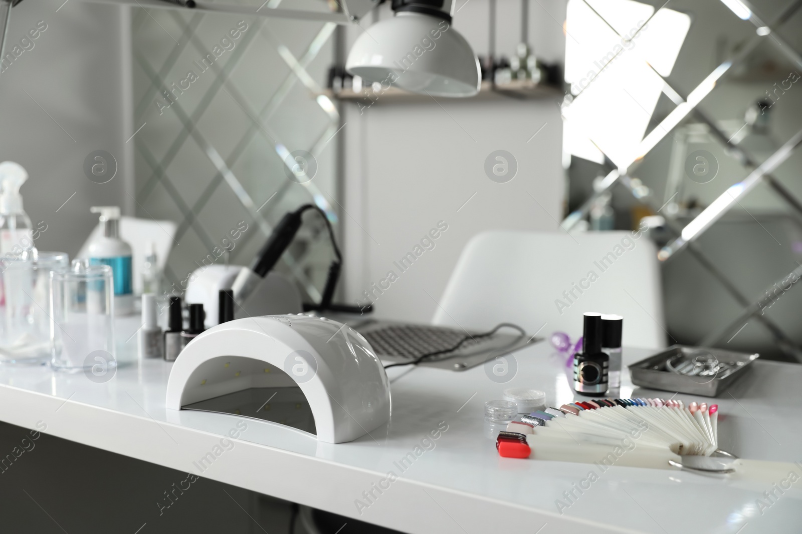 Photo of Professional equipment for manicure on table in beauty salon