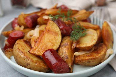 Delicious baked potato with thin dry smoked sausages, onion and dill on table, closeup