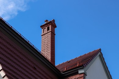 Photo of Beautiful house with brown roof against blue sky
