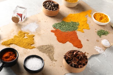World map of different spices and products on light grey marble table