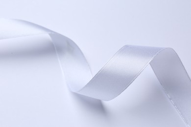 Photo of One beautiful silk ribbon on white background