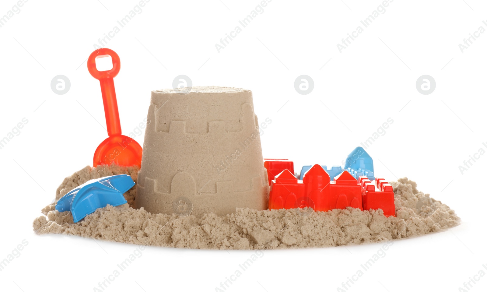 Photo of Plastic beach toys and figure on pile of sand against white background. Outdoor play