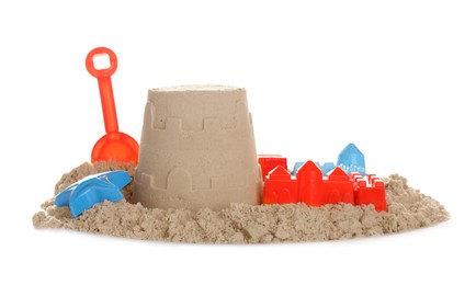 Photo of Plastic beach toys and figure on pile of sand against white background. Outdoor play