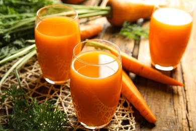 Freshly made carrot juice on wooden table