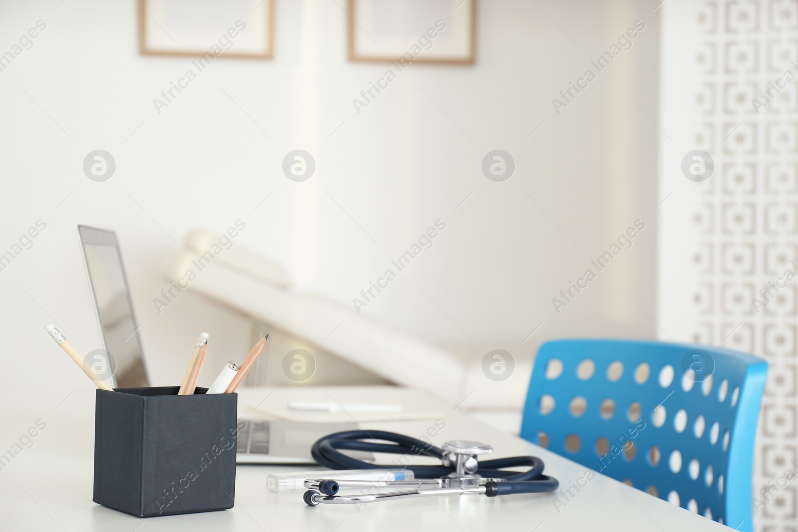 Photo of Doctor's workplace with modern laptop in medical office