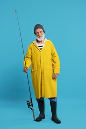 Fisherman with fishing rod on light blue background