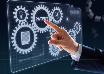 Patent concept. Man pressing button on virtual screen, closeup